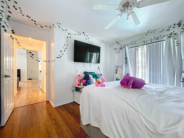 1599 Mcauliffe Ln, Palm Harbor, FL 34683 - bedroom featuring wood finished floors, a ceiling fan, and baseboards