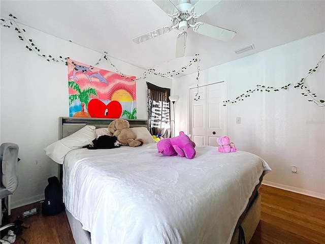 1599 Mcauliffe Ln, Palm Harbor, FL 34683 - bedroom featuring wood finished floors, baseboards, a ceiling fan, and a closet