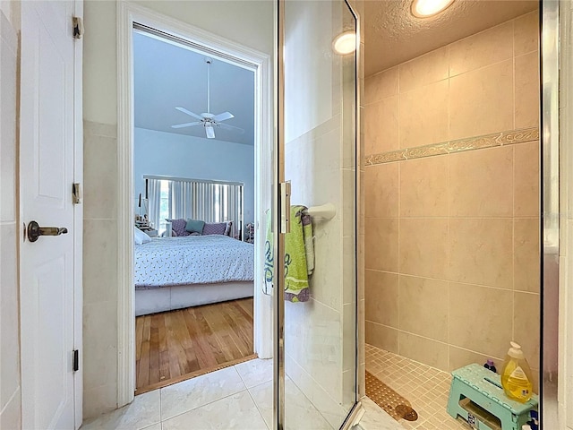 1599 Mcauliffe Ln, Palm Harbor, FL 34683 - ensuite bathroom featuring a shower stall, ceiling fan, and tile patterned floors
