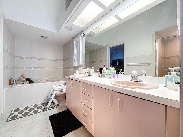 1599 Mcauliffe Ln, Palm Harbor, FL 34683 - full bath featuring tile walls, double vanity, a bath, and tile patterned floors