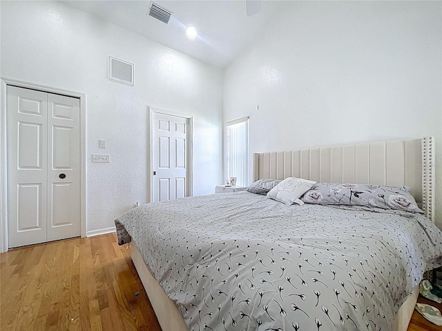 1599 Mcauliffe Ln, Palm Harbor, FL 34683 - bedroom with high vaulted ceiling, light wood-style floors, and baseboards