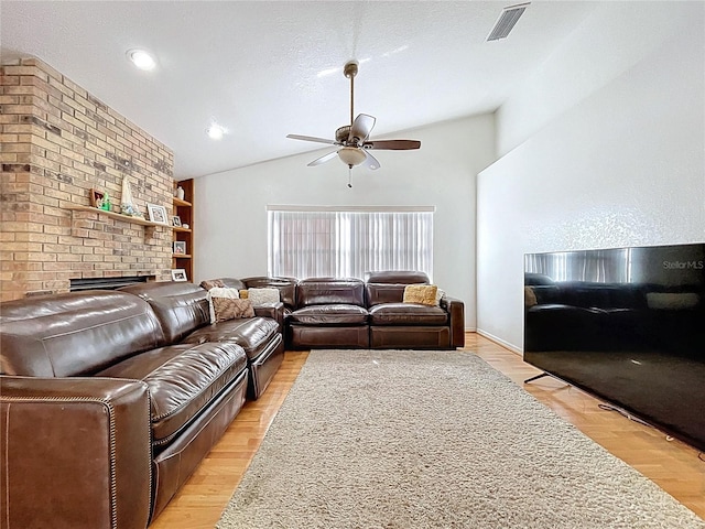 1599 Mcauliffe Ln, Palm Harbor, FL 34683 - living room with ceiling fan, lofted ceiling, and a fireplace