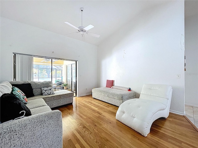 1599 Mcauliffe Ln, Palm Harbor, FL 34683 - bedroom with lofted ceiling, access to exterior, light wood-type flooring, a ceiling fan, and baseboards