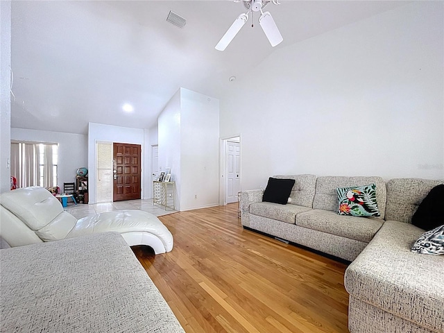 1599 Mcauliffe Ln, Palm Harbor, FL 34683 - living area with ceiling fan, light wood finished floors, and high vaulted ceiling