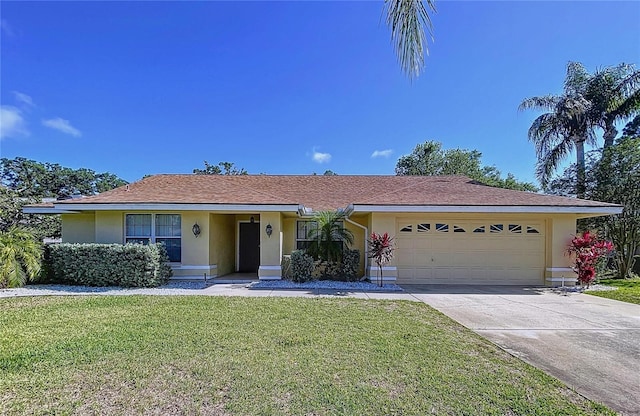 1599 Mcauliffe Ln, Palm Harbor, FL 34683 - ranch-style home featuring stucco siding, a front yard, an attached garage, and driveway