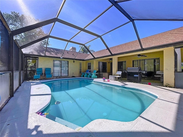 1599 Mcauliffe Ln, Palm Harbor, FL 34683 - outdoor pool with a ceiling fan, a patio, and glass enclosure