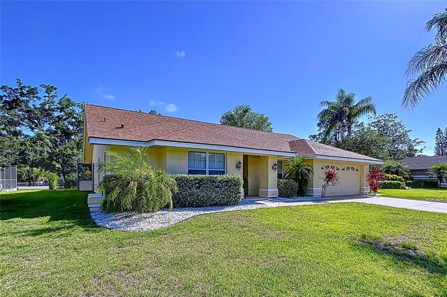 1599 Mcauliffe Ln, Palm Harbor, FL 34683 - ranch-style home featuring stucco siding, an attached garage, driveway, and a front yard