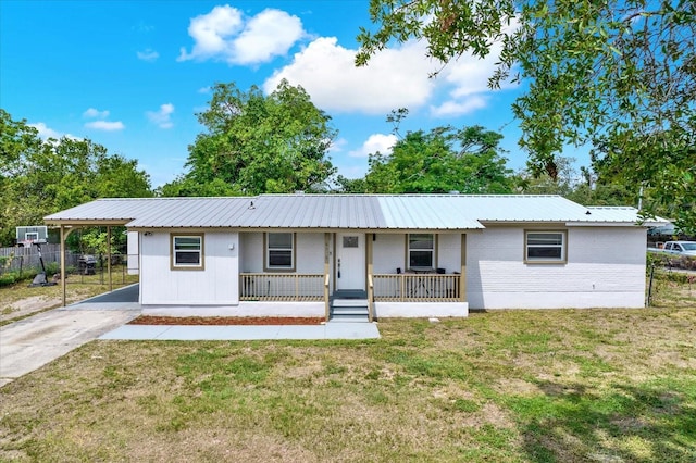 6020 N 50th St, Tampa, FL 33610 - ranch-style home featuring covered porch, driveway, metal roof, brick siding, and an attached carport