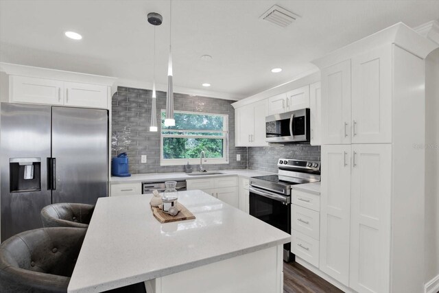 6020 N 50th St, Tampa, FL 33610 - kitchen with appliances with stainless steel finishes, a sink, tasteful backsplash, a center island, and recessed lighting