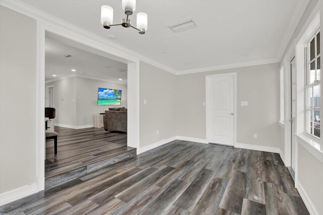 6020 N 50th St, Tampa, FL 33610 - unfurnished living room with a chandelier, dark wood finished floors, baseboards, ornamental molding, and recessed lighting