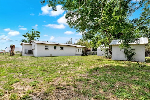 6020 N 50th St, Tampa, FL 33610 - back of property featuring a storage unit, metal roof, and an outdoor structure