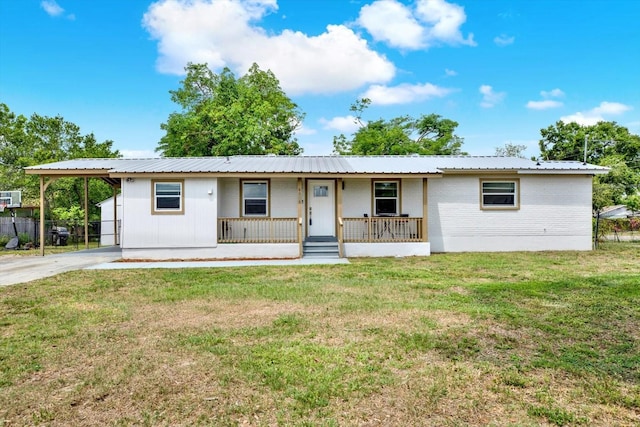 6020 N 50th St, Tampa, FL 33610 - ranch-style house with covered porch, a carport, metal roof, and brick siding
