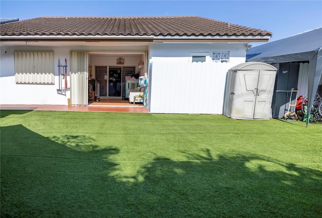 2901 SW 136th Ct, Miami, FL 33175 - rear view of property with a tiled roof, a yard, and a storage unit