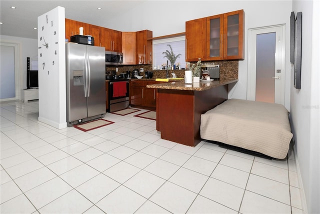 2901 SW 136th Ct, Miami, FL 33175 - kitchen with stainless steel appliances, a peninsula, tasteful backsplash, glass insert cabinets, and brown cabinetry