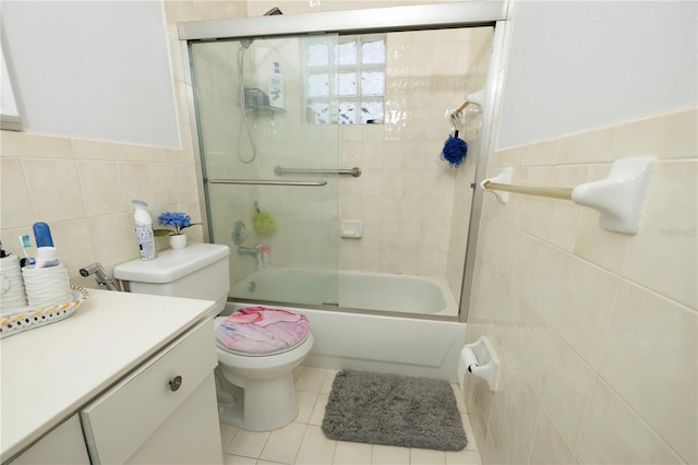 2901 SW 136th Ct, Miami, FL 33175 - bathroom featuring tile walls, tile patterned flooring, toilet, combined bath / shower with glass door, and vanity