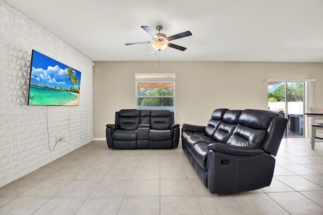 5067 Sable Chime Dr, Wimauma, FL 33598 - living room featuring ceiling fan, baseboards, light tile patterned floors, and an accent wall
