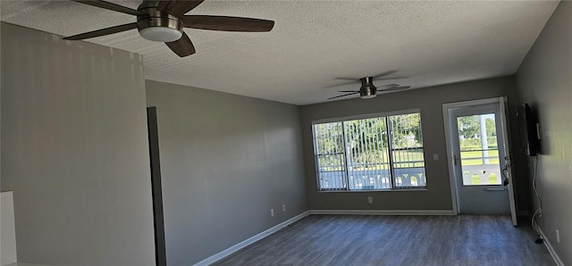 unfurnished room with a ceiling fan, dark wood-type flooring, a textured ceiling, and baseboards