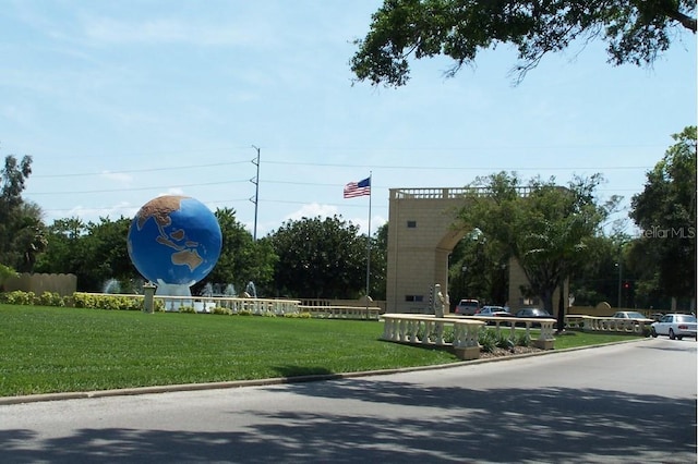 view of property's community with a lawn