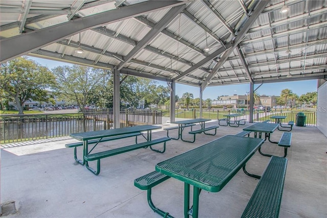 view of property's community featuring fence, a water view, and a gazebo