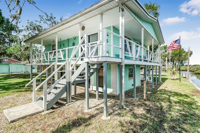 2220 S Coon Pt, Crystal River, FL 34429 - view of side of property with a lawn and covered porch