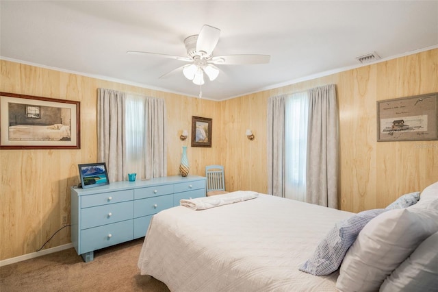 2220 S Coon Pt, Crystal River, FL 34429 - carpeted bedroom with crown molding, wooden walls, ceiling fan, and baseboards