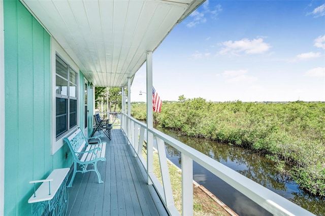 2220 S Coon Pt, Crystal River, FL 34429 - wooden deck with a water view and covered porch