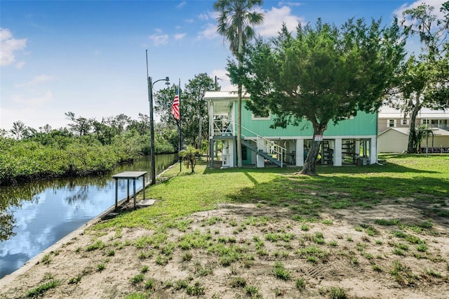 2220 S Coon Pt, Crystal River, FL 34429 - view of green lawn with stairs and a water view