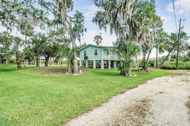 2220 S Coon Pt, Crystal River, FL 34429 - view of grassy yard with a balcony and gravel driveway