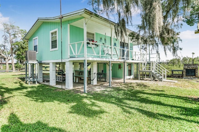 2220 S Coon Pt, Crystal River, FL 34429 - rear view of house with stairway, a yard, a wooden deck, and a patio