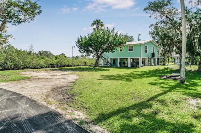 2220 S Coon Pt, Crystal River, FL 34429 - view of grassy yard with stairway and dirt driveway