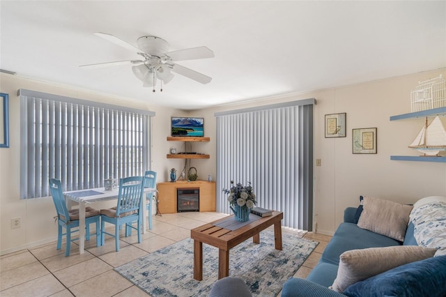 2220 S Coon Pt, Crystal River, FL 34429 - living room featuring light tile patterned floors, a ceiling fan, baseboards, wine cooler, and a glass covered fireplace