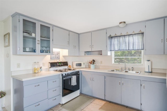 2220 S Coon Pt, Crystal River, FL 34429 - kitchen with white appliances, a sink, gray cabinets, and glass insert cabinets