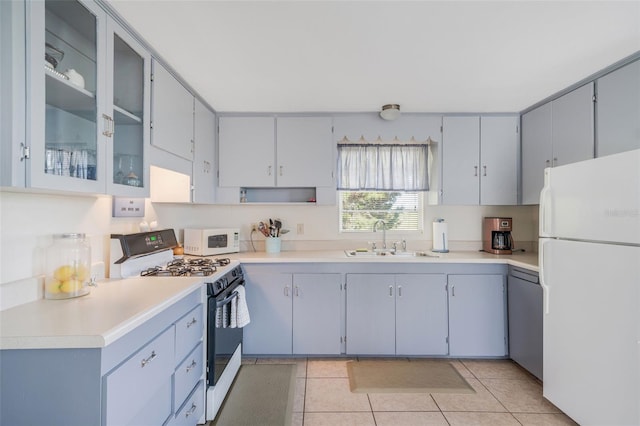 2220 S Coon Pt, Crystal River, FL 34429 - kitchen featuring white appliances, a sink, light tile patterned floors, light countertops, and glass insert cabinets