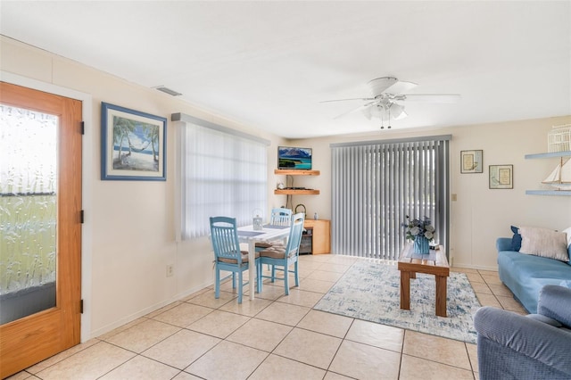 2220 S Coon Pt, Crystal River, FL 34429 - living area featuring a ceiling fan, light tile patterned floors, and baseboards
