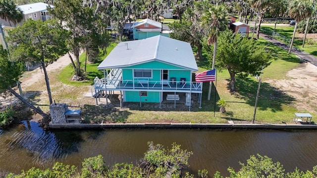 2220 S Coon Pt, Crystal River, FL 34429 - back of property featuring a deck with water view, stairs, and a lawn