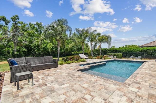 view of swimming pool featuring a patio and fence