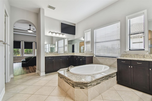 full bath with a ceiling fan, tile patterned flooring, a bath, and vanity