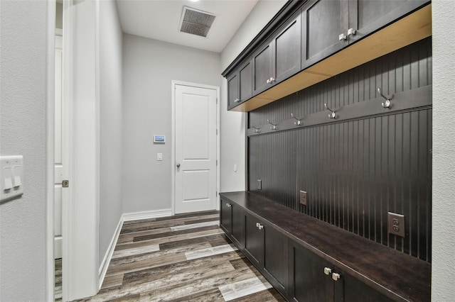 mudroom with wood finished floors and baseboards
