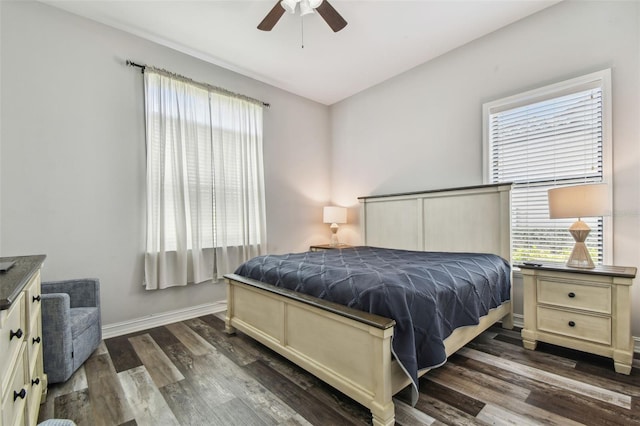 bedroom with dark wood-type flooring, baseboards, and ceiling fan