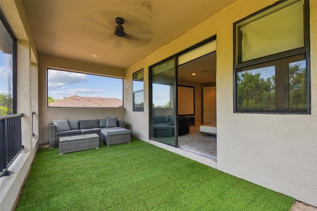 view of grassy yard featuring a balcony and an outdoor hangout area