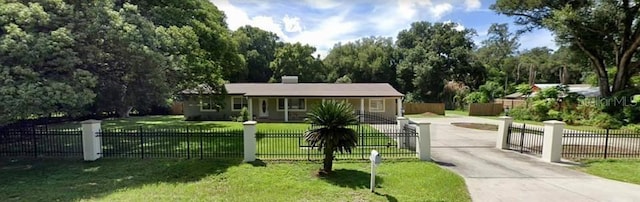 view of front facade with driveway and a chimney