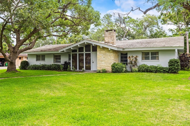 1675 Robin Hood Ln, Clearwater, FL 33764 - view of front of home featuring a chimney, a front yard, stucco siding, and stone siding