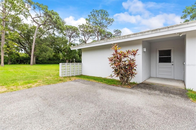 1675 Robin Hood Ln, Clearwater, FL 33764 - view of home's exterior featuring stucco siding and a yard