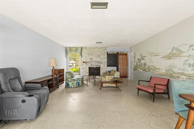 1675 Robin Hood Ln, Clearwater, FL 33764 - living room featuring speckle patterned floor and a stone fireplace