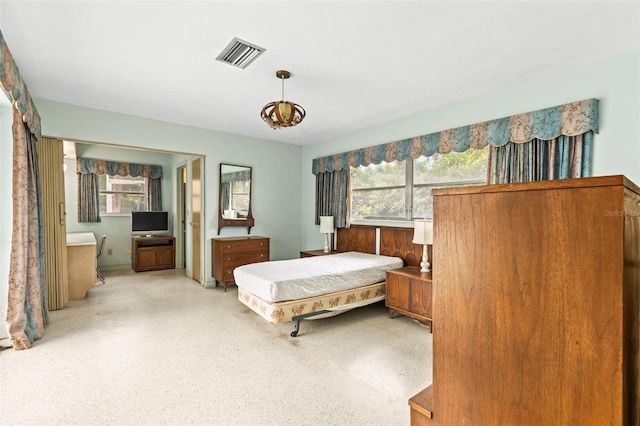 1675 Robin Hood Ln, Clearwater, FL 33764 - bedroom featuring dark speckled floor and ensuite bath