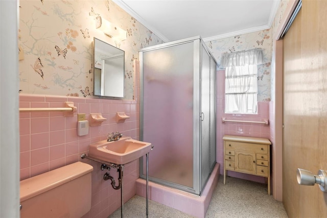 1675 Robin Hood Ln, Clearwater, FL 33764 - bathroom with tile walls, crown molding, toilet, a stall shower, and wainscoting