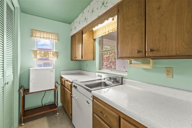 1675 Robin Hood Ln, Clearwater, FL 33764 - kitchen with brown cabinetry, a sink, plenty of natural light, and light countertops