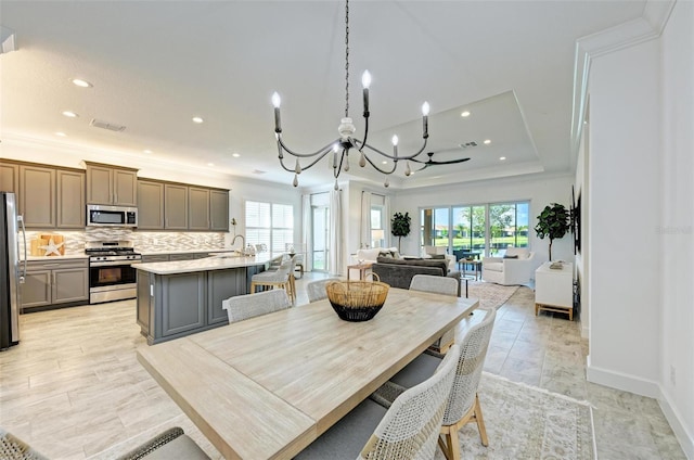 15525 Corona Del Mar Dr, Wimauma, FL 33598 - dining room with a chandelier, recessed lighting, crown molding, baseboards, and a raised ceiling