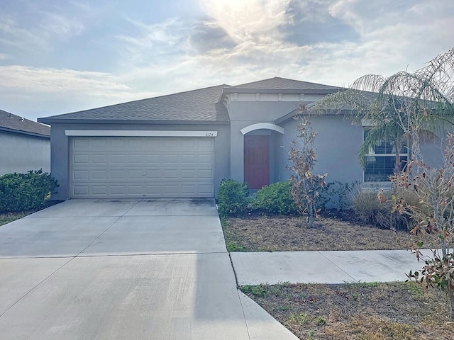 11524 Sage Canyon Dr, Riverview, FL 33578 - view of front of property with a garage, concrete driveway, stucco siding, and a shingled roof