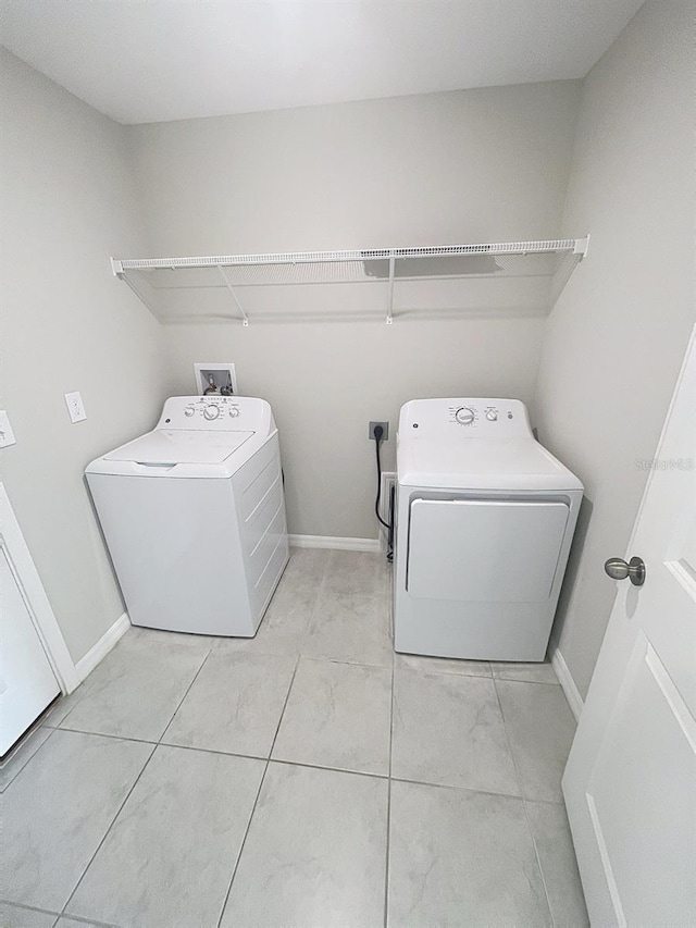 11524 Sage Canyon Dr, Riverview, FL 33578 - laundry area featuring separate washer and dryer, baseboards, and light tile patterned floors